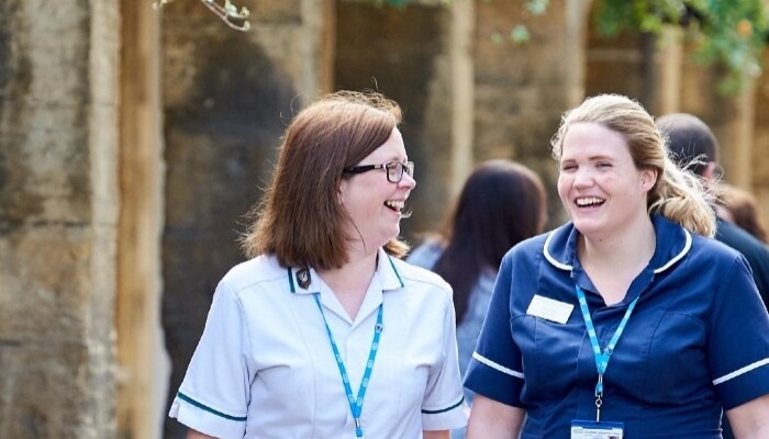 Two community nurses talking.