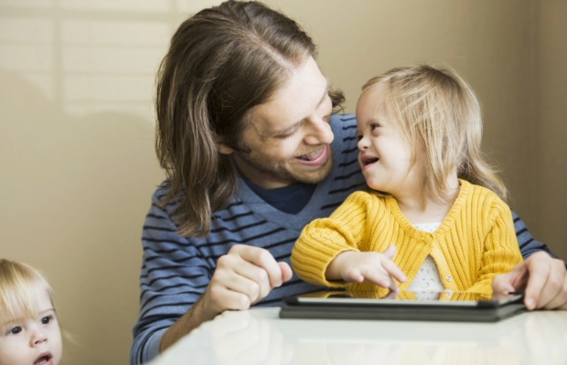 Man and child using a tablet.