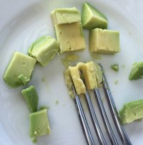 chopped avocados with a fork