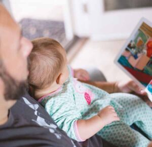 Baby with parent reading them a book