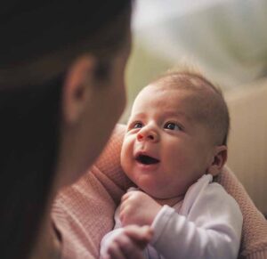 baby smiling with the mother