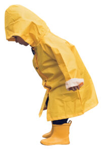Little boy walking outdoors at rainy autumn day
