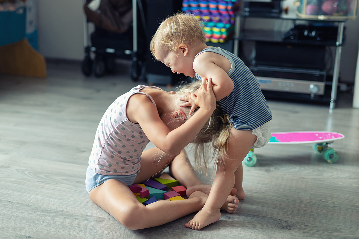 Two little siblings children fighting