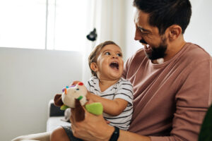 Father and baby son with teddy bear