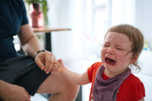 little girl crying hard, standing 