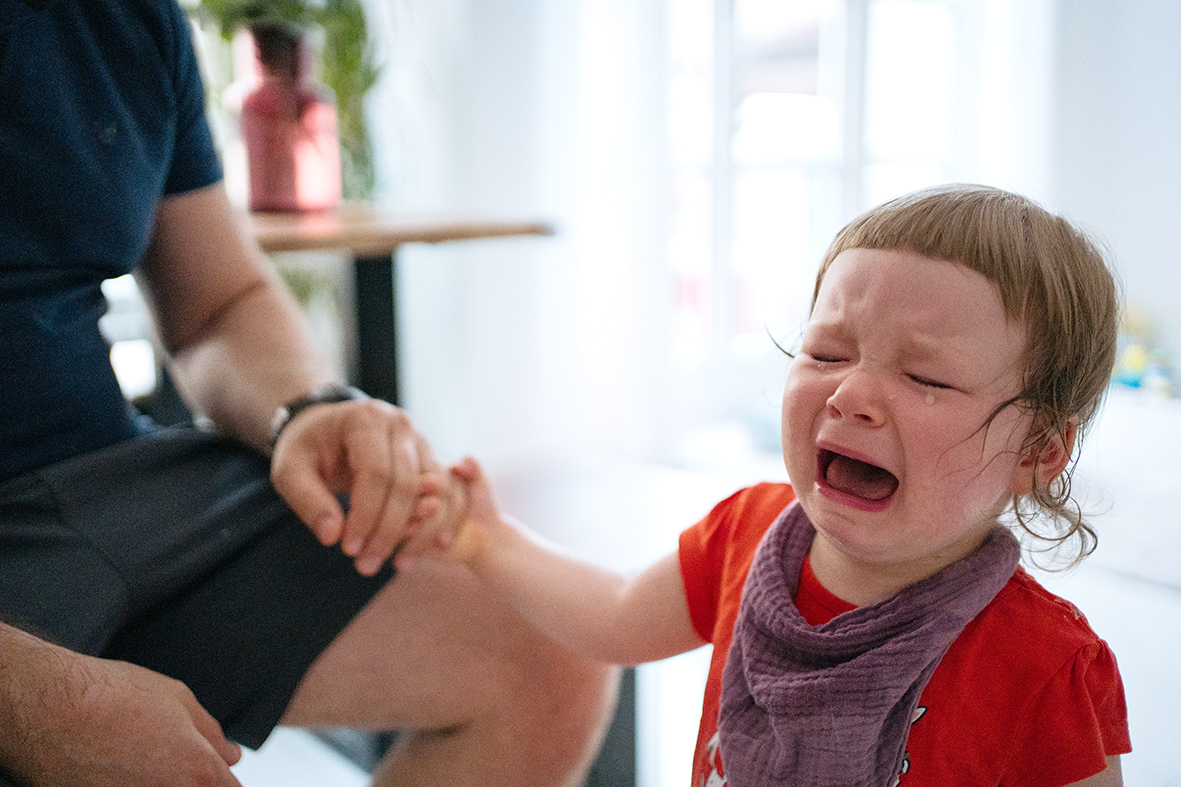 little girl crying hard, standing