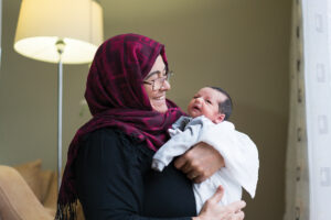 Grandmother holding newborn baby boy