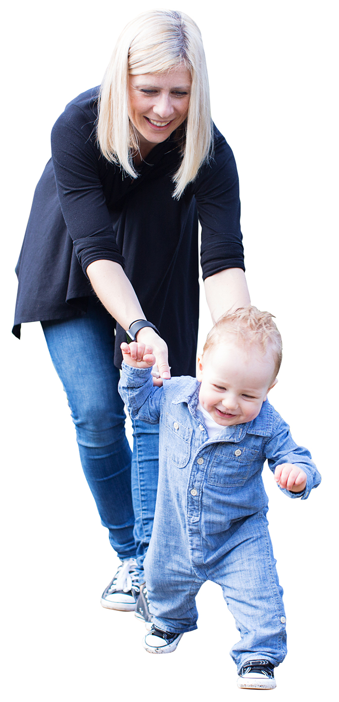 laughing cute toddler boy running away from young mother making first steps enjoying time together in the park