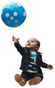 toddler playing with baloon
