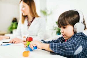 Boy wearing headphones playing with toys