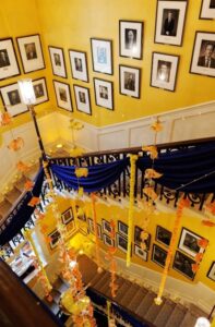 inside of number 10 showing the stairs and images of past UK prime ministers