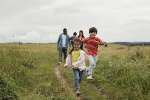 A three generation family walking through the countryside