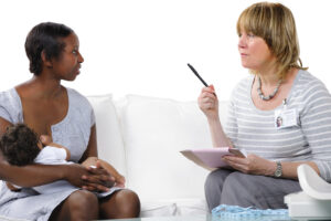 Healthcare professional speaking to a mother